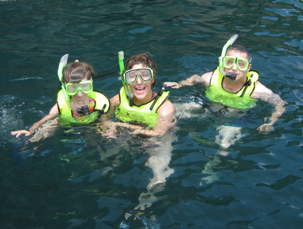 Family snorkeling at Colomitos Beach