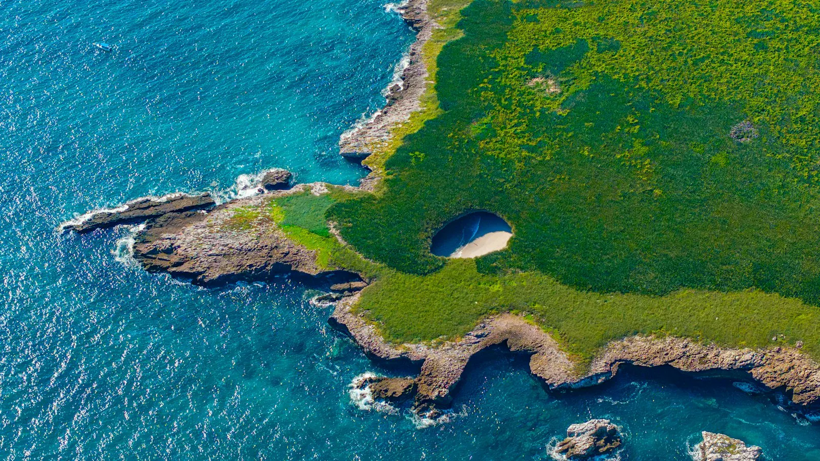 Aerial view of the Marietas Islands' Hidden Beach, a sinkhole opening onto a sandy cove surrounded by turquoise water