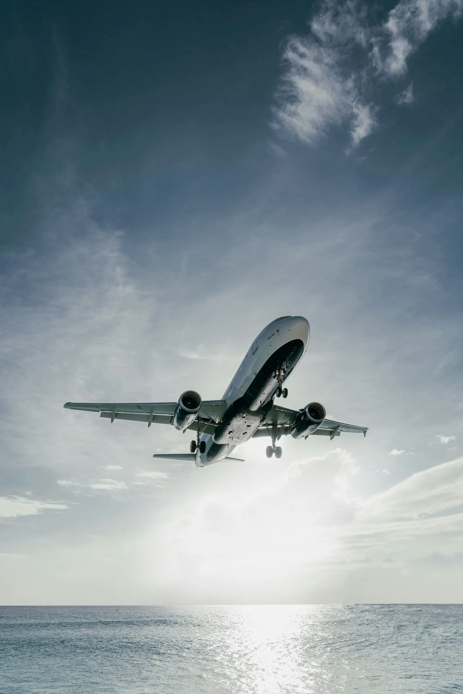 Airplane descending toward the ocean during final approach