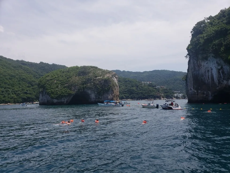 Boats and snorkelers at the Los Arcos rock arches