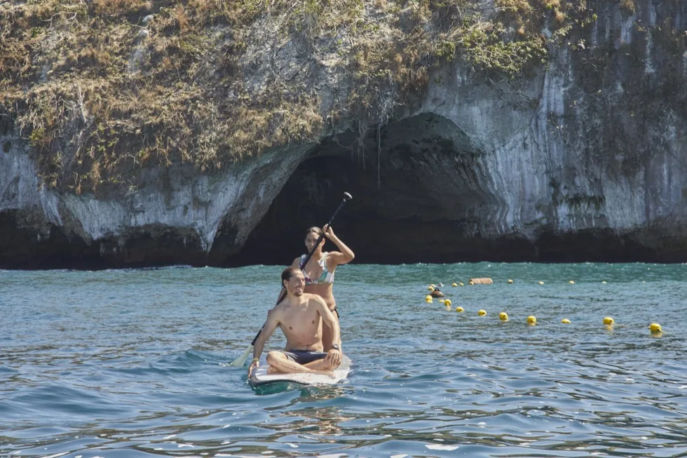 Guide photographing a group of snorkelers near Los Arcos