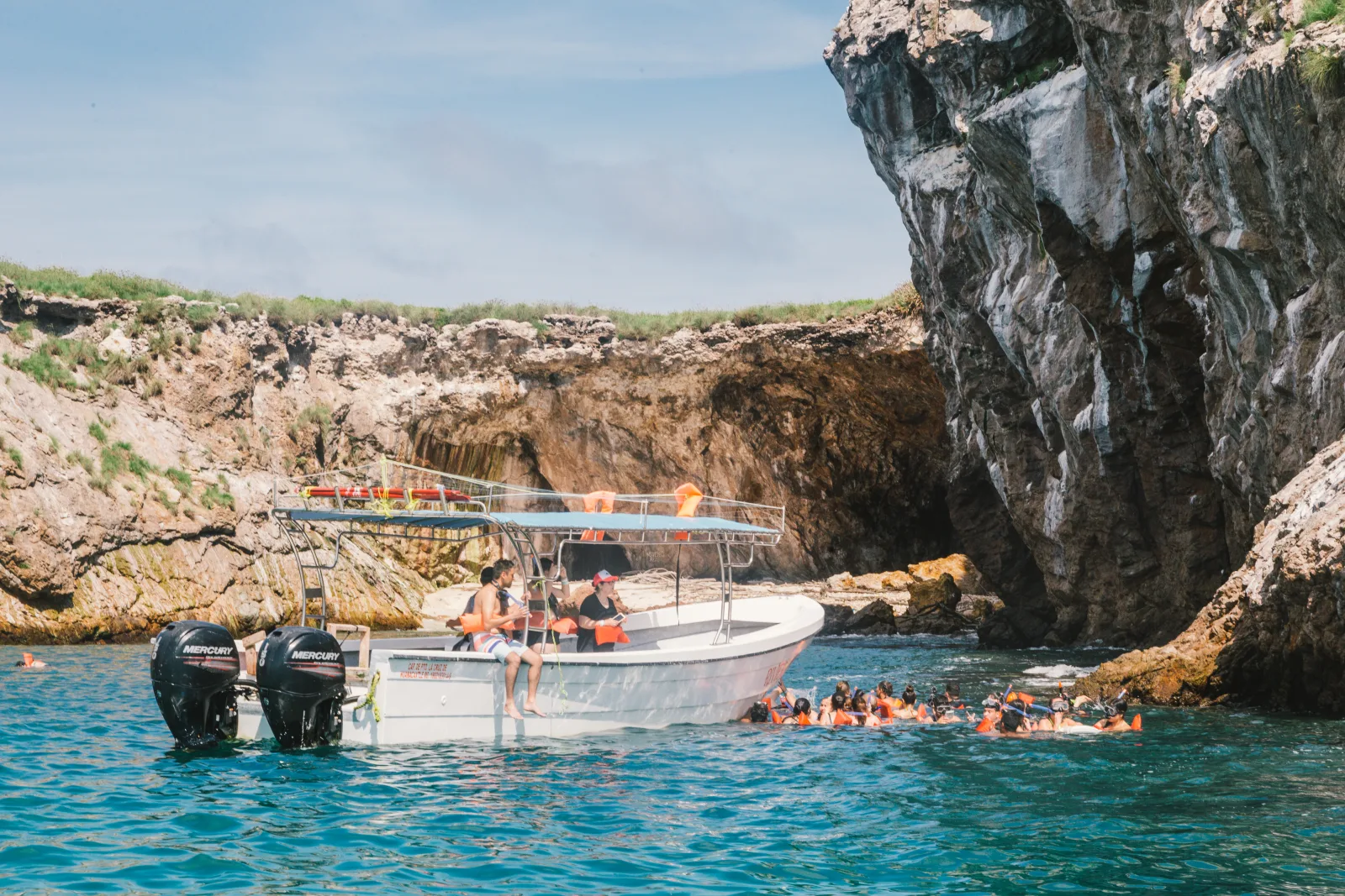 Boat in front of the Marietas with passengers observing the islands