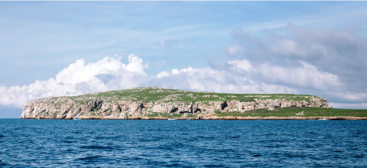 View of Islas Marietas from the sea, with rocky cliffs covered in vegetation