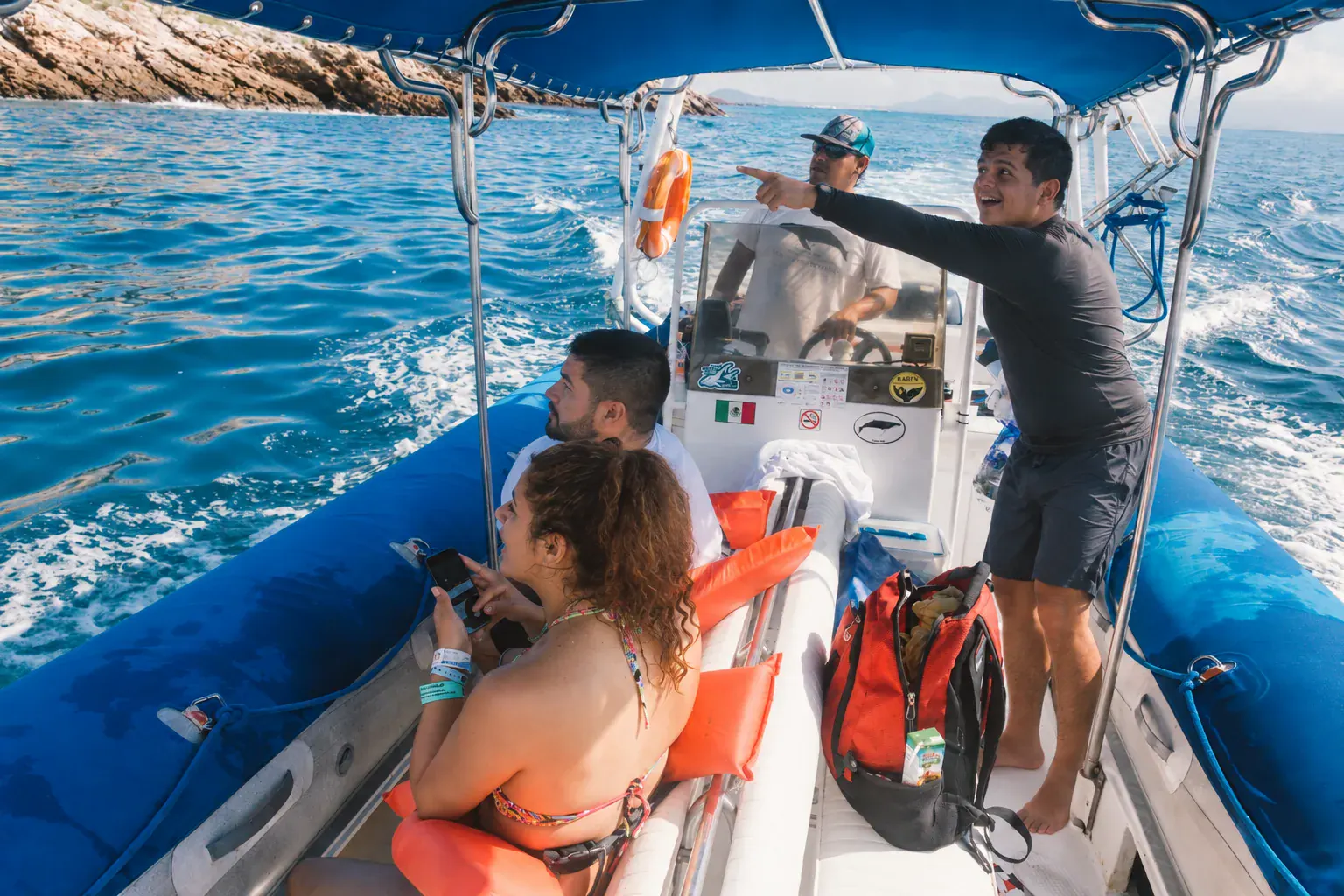 Ecotours naturalist guide pointing out birds and explaining the islands