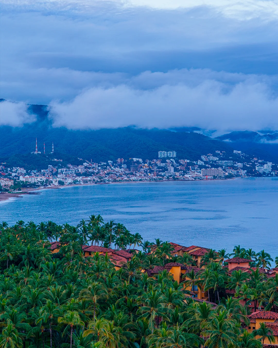 Aerial view of Banderas Bay surrounded by mountains, with Puerto Vallarta on the far shore