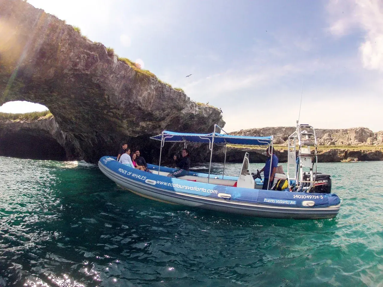 Small Ecotours Vallarta group aboard a boat exploring the rock arches at Los Arcos