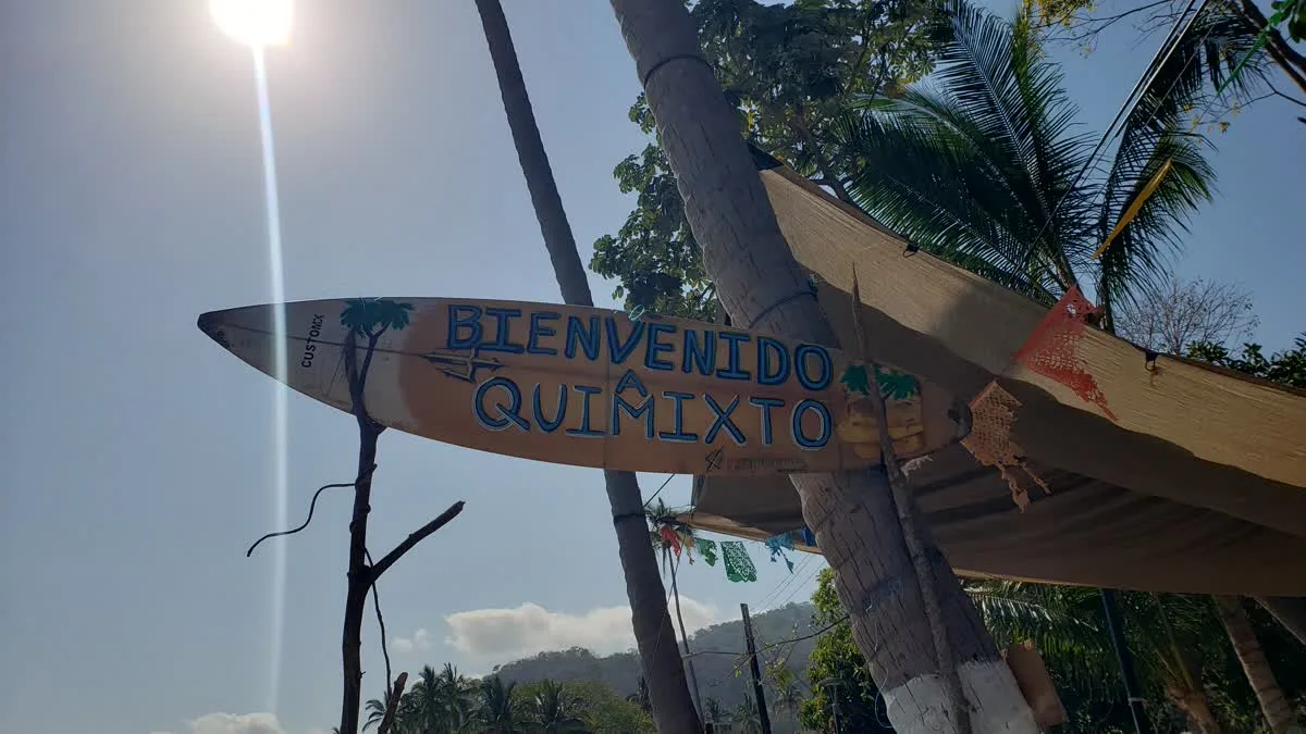 Welcome sign painted on a surfboard in the village of Quimixto