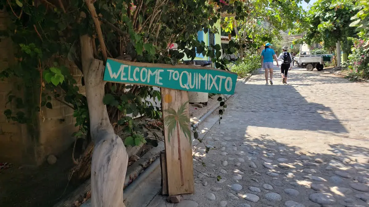 Welcome to Quimixto sign along the cobblestone village street