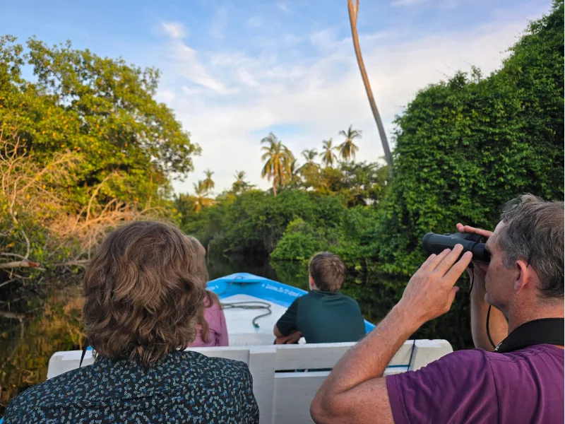 Birdwatchers on a boat with binoculars